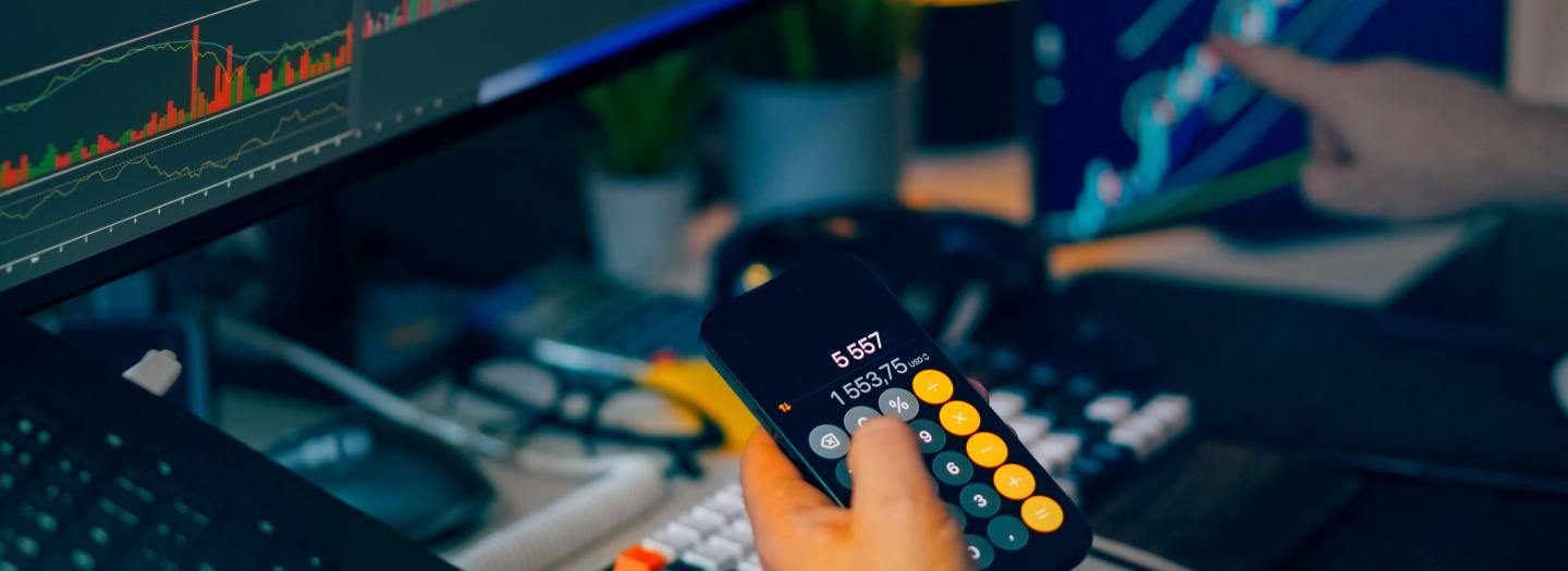 An employee making calculations on a device