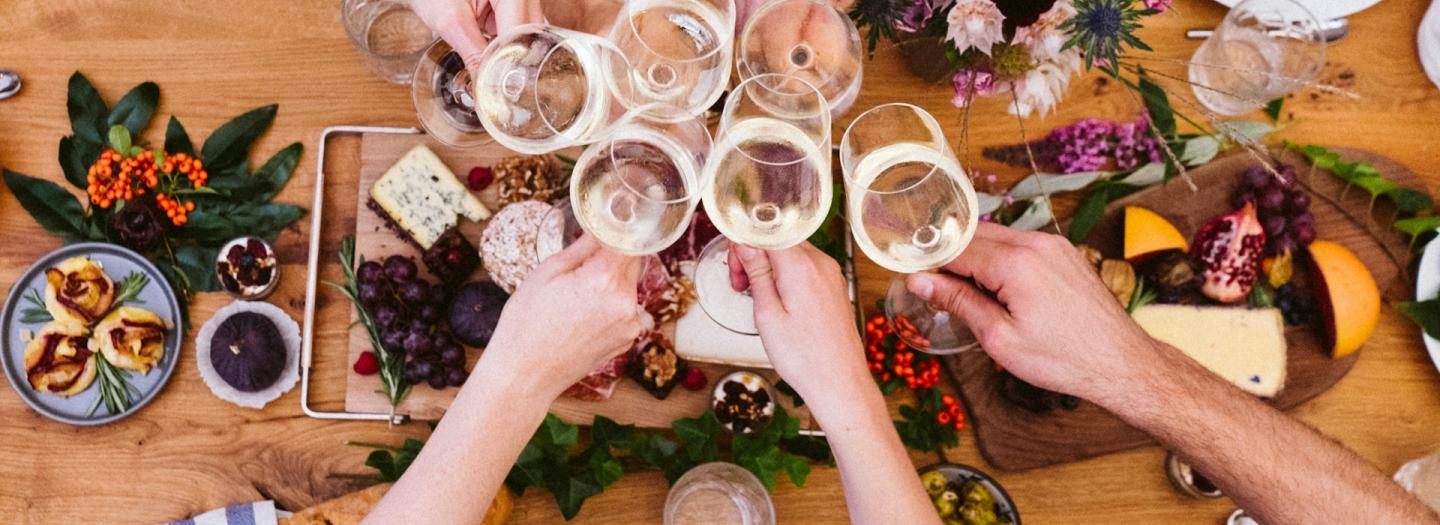 A group of people raising their glasses for a toast